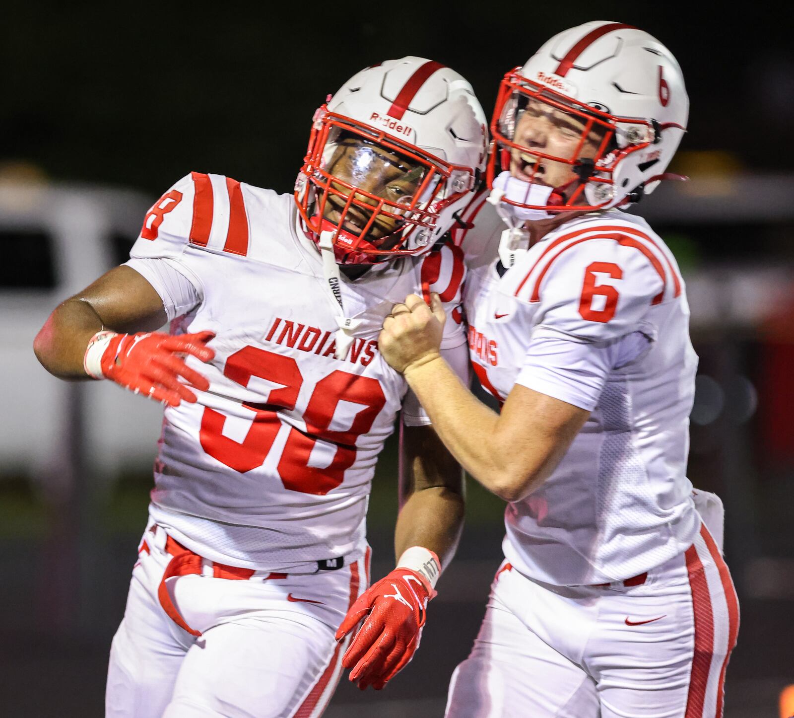 Fairfield senior quarterback Dominic Back (right) celebrates with freshman running back Corrious Booker after Booker scored on a 35-yard touchdown run late in the fourth quarter of a nonconference game on Friday, Aug. 22 at Heidkamp Stadium in Huber Heights. BRYANT BILLING / STAFF