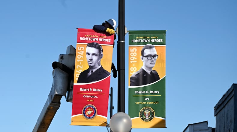 Pictured Travis Jenkins, an employee with the Hamilton Department of Infrastructure, installing on Wednesday, April 30, 2025, a Hometown Hero banner along Main Street. There will be more than 600 installed around the city on display through Veterans Day, Nov. 11, 2025. MICHAEL D. PITMAN/STAFF