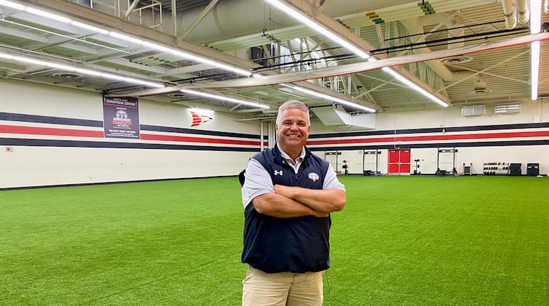For the first time in Lakota Schools’ history some of its teenage student athletes and gym students can now train and exercise on an indoor synthetic turf practice field. The recently installed turf at Lakota West High School is part of a renovation of a former auxiliary gym – known as the school’s upper gym - next to the West Chester Twp.’s school main sports arena. Pictured is West Athletic Director Scott Kaufman. (Photo By Michael D. Clark/ Journal-News)
