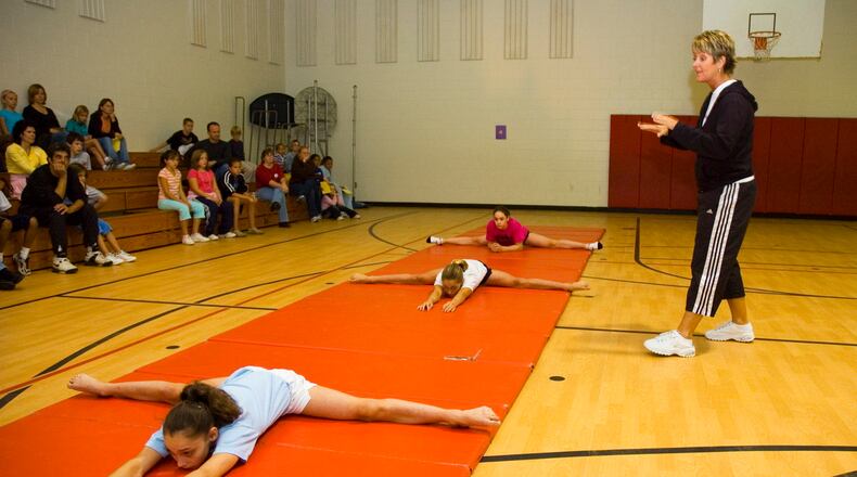 Coach Mary Lee Tracy, in a 2006 photo, works with gymnasts. NICHOLAS S. GRAHAM