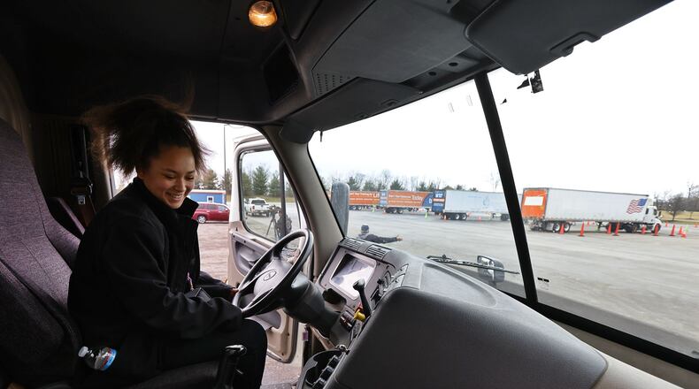 Nina Haynes, 17, a senior student from Middletown High School, climbs in a truck on Tuesday to get a glimpse of many job and training opportunities available during an Experiential Learning Day at the CDL driver training pad at Butler Tech. NICK GRAHAM/STAFF