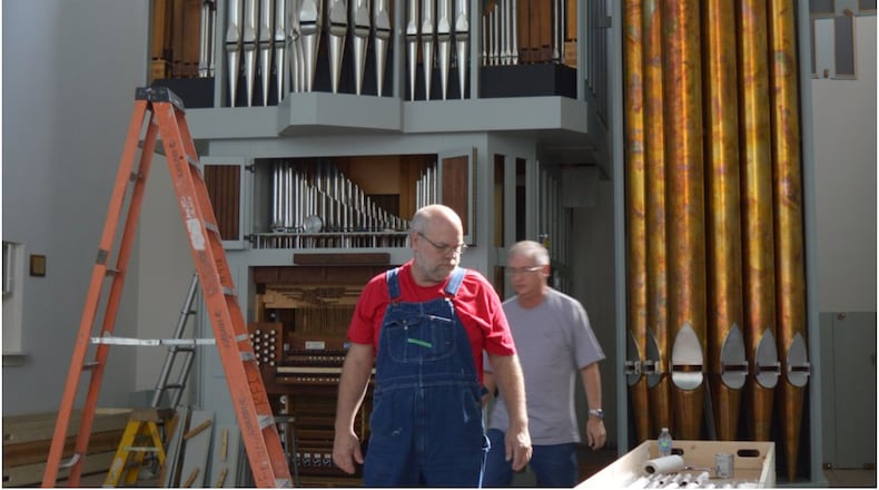 Paul Nordlie, front, and tonal director Eric Grame look for a needed part for the organ being installed in Holy Trinity Episcopal Church as it took shape. The congregation is looking to use it for its Oct. 1 service. CONTRIBUTED/BOB RATTERMAN