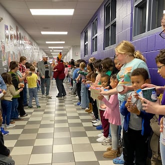 For more than a decade Middletown’s Central Elementary has made packing Thanksgiving meals and other items for needy local families a total school event.
The school’s annual “Turkey Pass” sees hundreds of the students line up in the school’s main hallway leading to the cafeteria and then each donated Thanksgiving food and care item is passed from one student’s hands to another. (Photo By Michael D. Clark/Journal-News)