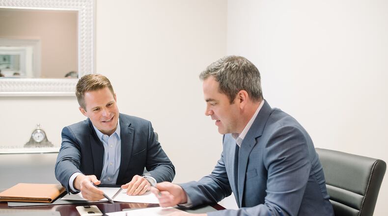 Dan Johnson, chief executive officer and a wealth adviser at Birchcreek Wealth Management in Miami Township, discusses financial planning with Matt Will, a wealth adviser at Birchcreek. CONTRIBUTED