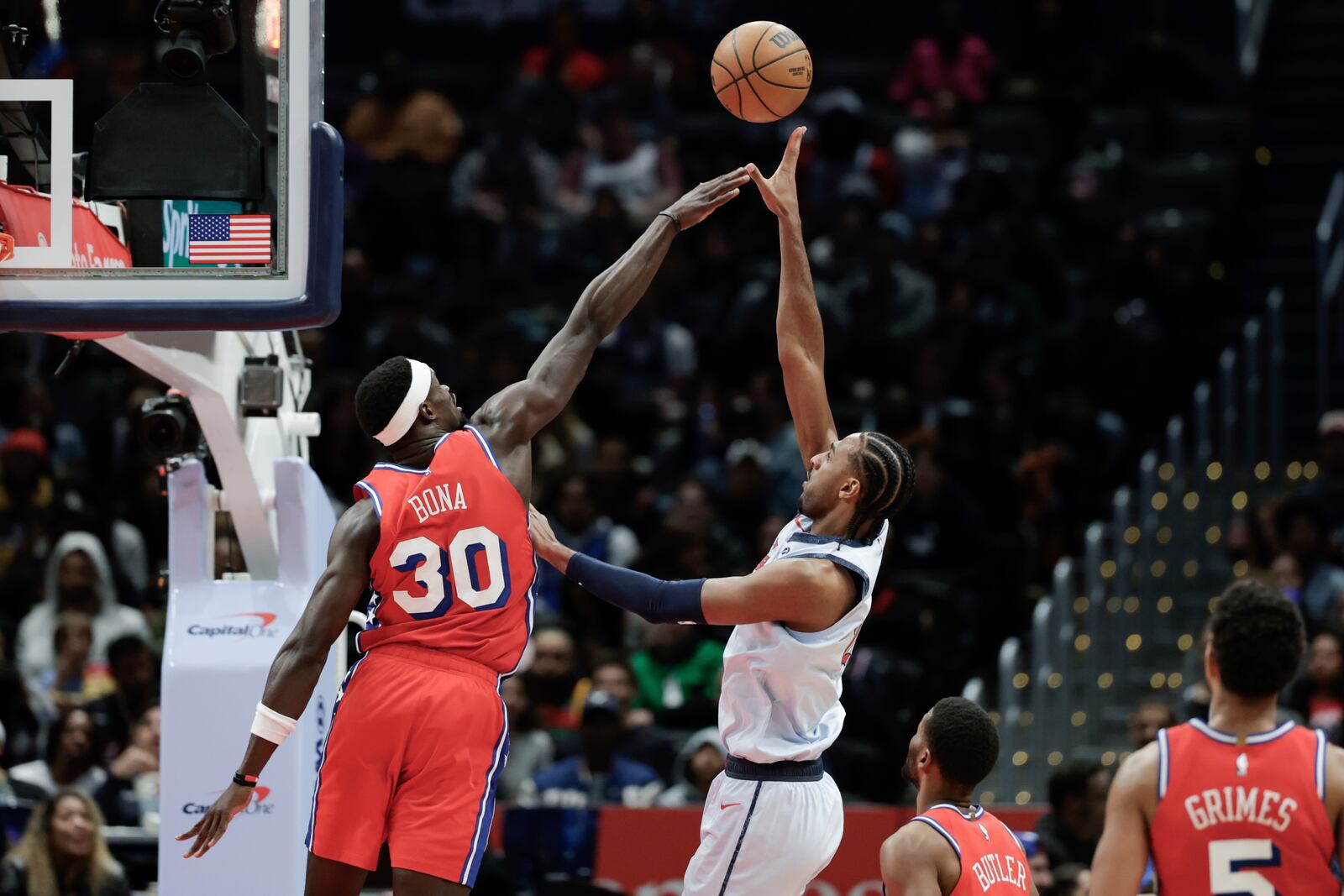 Washington Wizards forward Alex Sarr shoots the ball over Philadelphia 76ers center Adem Bona (30) during the second half of an NBA basketball game in Washington, Wednesday, April 9, 2025. (AP Photo/Terrance Williams)