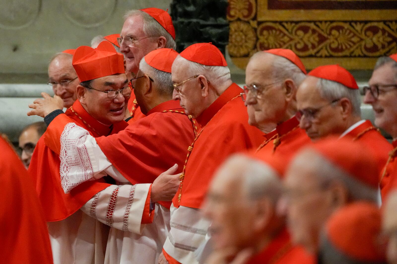 FILE - Cardinal Tarcisio Isao Kikuchi, Archbishop of Tokyo, left, is congratulated by fellow cardinals after being elevated by Pope Francis during a solemn Mass in St. Peter's Basilica at the Vatican, Dec. 7, 2024. (AP Photo/Gregorio Borgia, File)