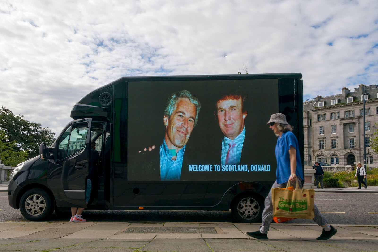 A photograph of US President Donald Trump and Jeffrey Epstein is displayed on the side of a van in Aberdeen city centre, during US President Donald Trump's five-day private trip to Scotland, Monday, July 28, 2025. (Jane Barlow/PA via AP)