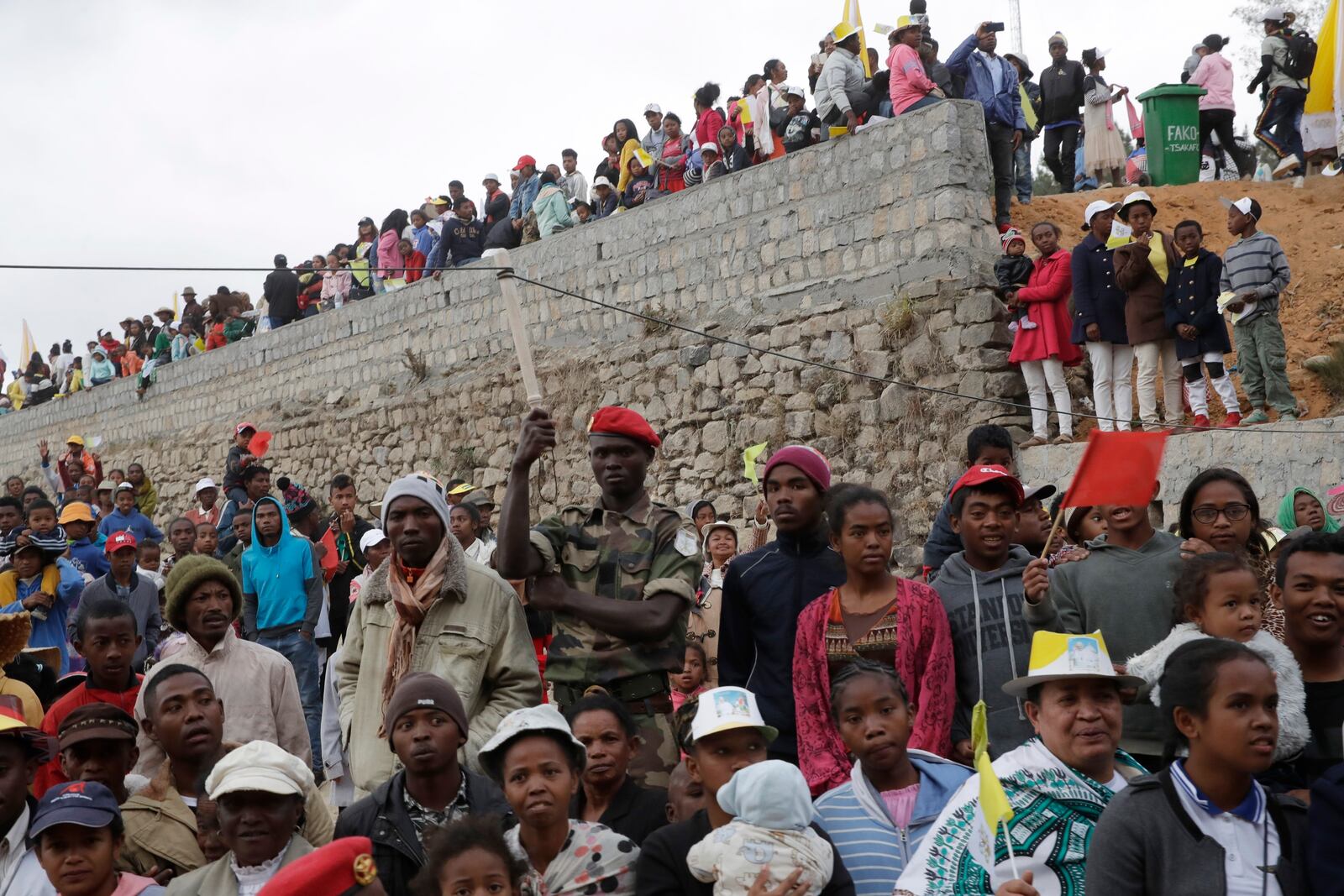 FILE - People listen to Pope Francis' speak during a prayer for workers at the Mahatzana work yard in Akamasoa, Madagascar, Sept. 8, 2019. (AP Photo/Alessandra Tarantino, File)