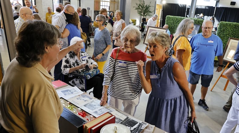 Butler County Historical Society executive director Kathy Creighton shows items on display to Former Champion Paper employees Barb Hendricks and Cheryl Lambertson, right, as Former Champion Paper employees toured Spooky Nook Sports Champion Mill Tuesday, Aug. 30, 2022. The Butler County Historical Society displayed photos and items from Champion. NICK GRAHAM/STAFF
