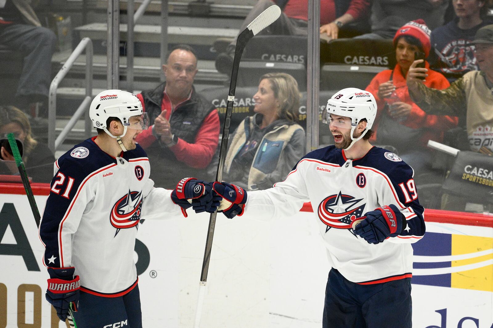 Columbus Blue Jackets center Adam Fantilli (19) celebrates his goal with left wing James van Riemsdyk (21) during the third period of an NHL hockey game against the Washington Capitals, Sunday, April 13, 2025, in Washington. (AP Photo/Nick Wass)