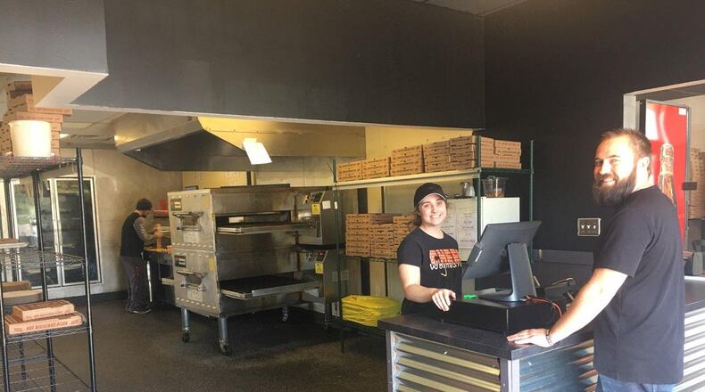 Madison Lowe waits on customer Eric Meador Monday at Roscoe’s Pizza.