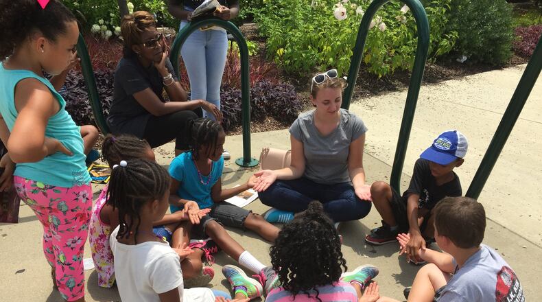 Bailey Plummer, a Summer Lunch Literacy intern from Bowling Green University, creates a teaching moment with teacher, Cynthia Shropshire s students, at their Cincinnati Zoo field trip.