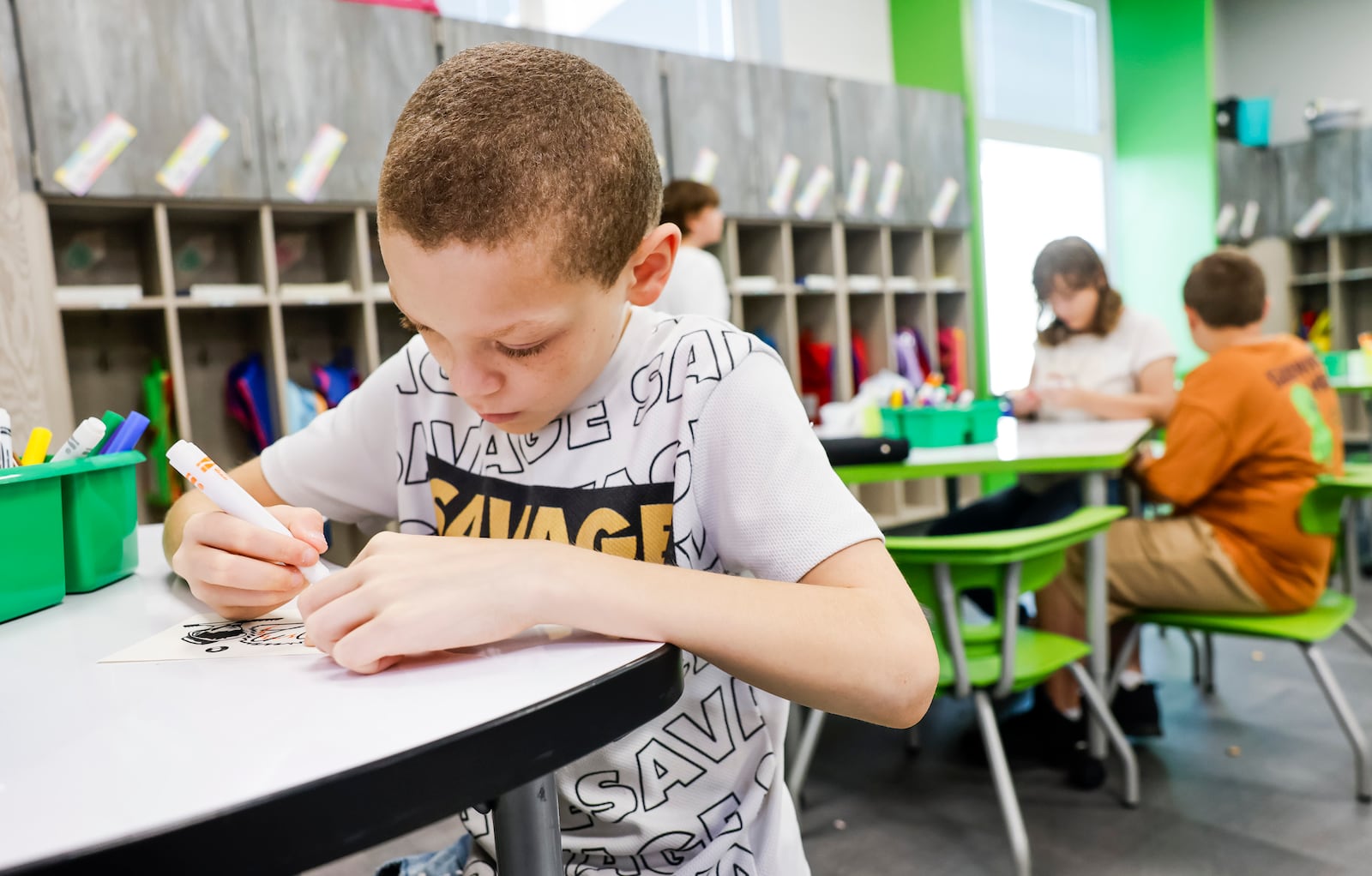 Sixth-grader Xaver Davenport does morning work on the first day at Rosa Parks Elementary School Monday, Aug. 18, 2025 in Middletown. The school district operates with a staggered start. NICK GRAHAM/STAFF