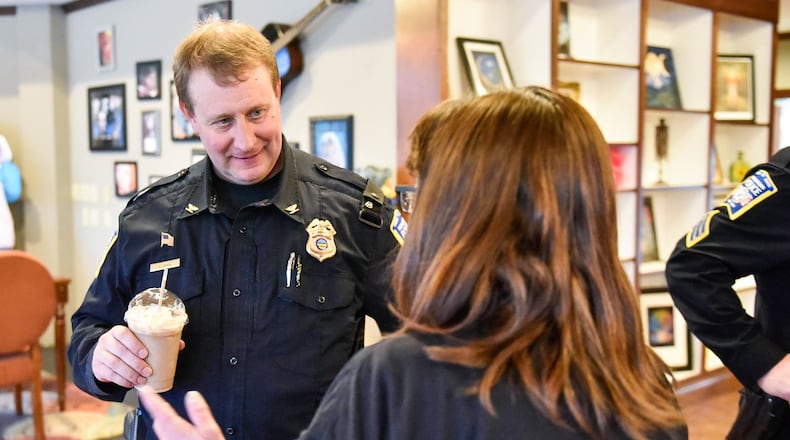 Middletown Police Chief David Birk talks to resident Liz Martin during coffee with the chief Tuesday, Jan. 28 at Triple Moon Coffee on Central Avenue in Middletown. Birk is planning to add a Community Oriented Policing and Traffic unit to work with the code enforcement unit. NICK GRAHAM / STAFF Middletown Police Chief David Birk talks to resident Liz Martin during coffee with the chief Tuesday, Jan. 28 at Triple Moon Coffee on Central Avenue in Middletown. NICK GRAHAM / STAFF