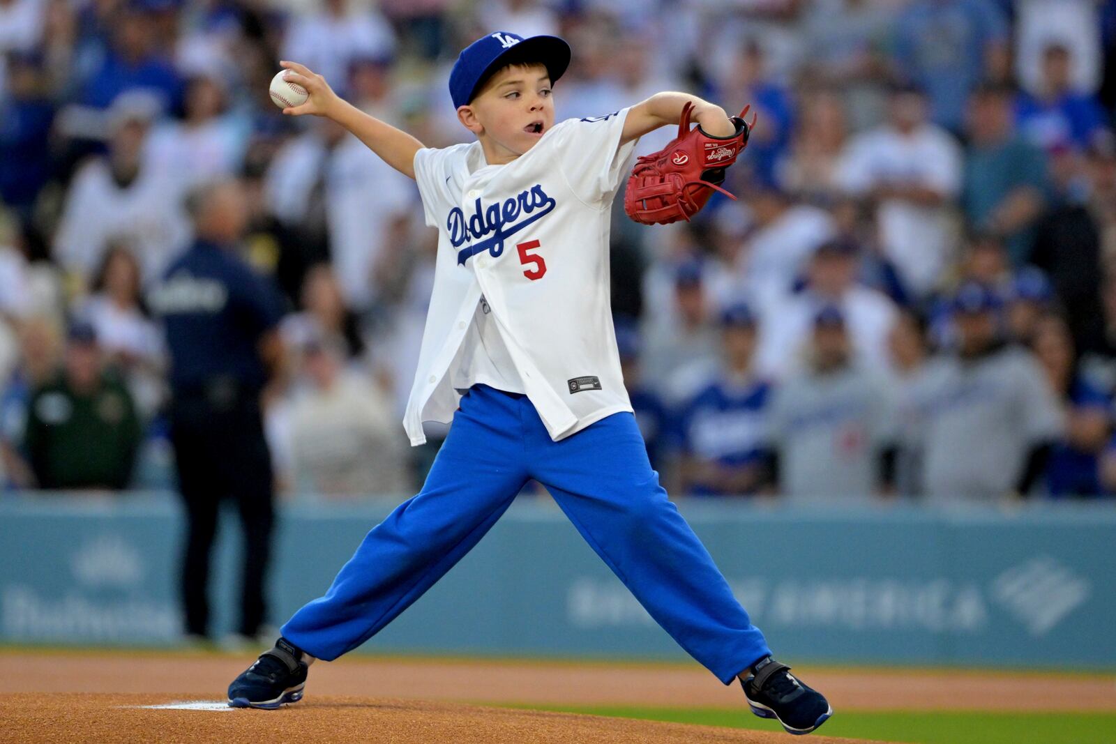 Charlie Freeman, 9-year-old son of Los Angeles Dodgers first baseman Freddie Freeman, throws out the first pitch before a baseball game against the Chicago Cubs, Friday, April 11, 2025, in Los Angeles. (AP Photo/Jayne Kamin-Oncea)