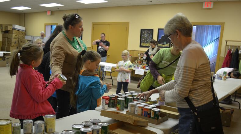 In this 2014 file photo, volunteers collect and sort more than 5,000 pounds of donated food as part of the Kiwanis Holiday Food Drive to benefit the Oxford Community Choice Pantry. Oxford city council has approved a resolution allowing the city manager to proceed with a lease contract of city park property for a new, 2,000-square-foot pantry building. CONTRIBUTED