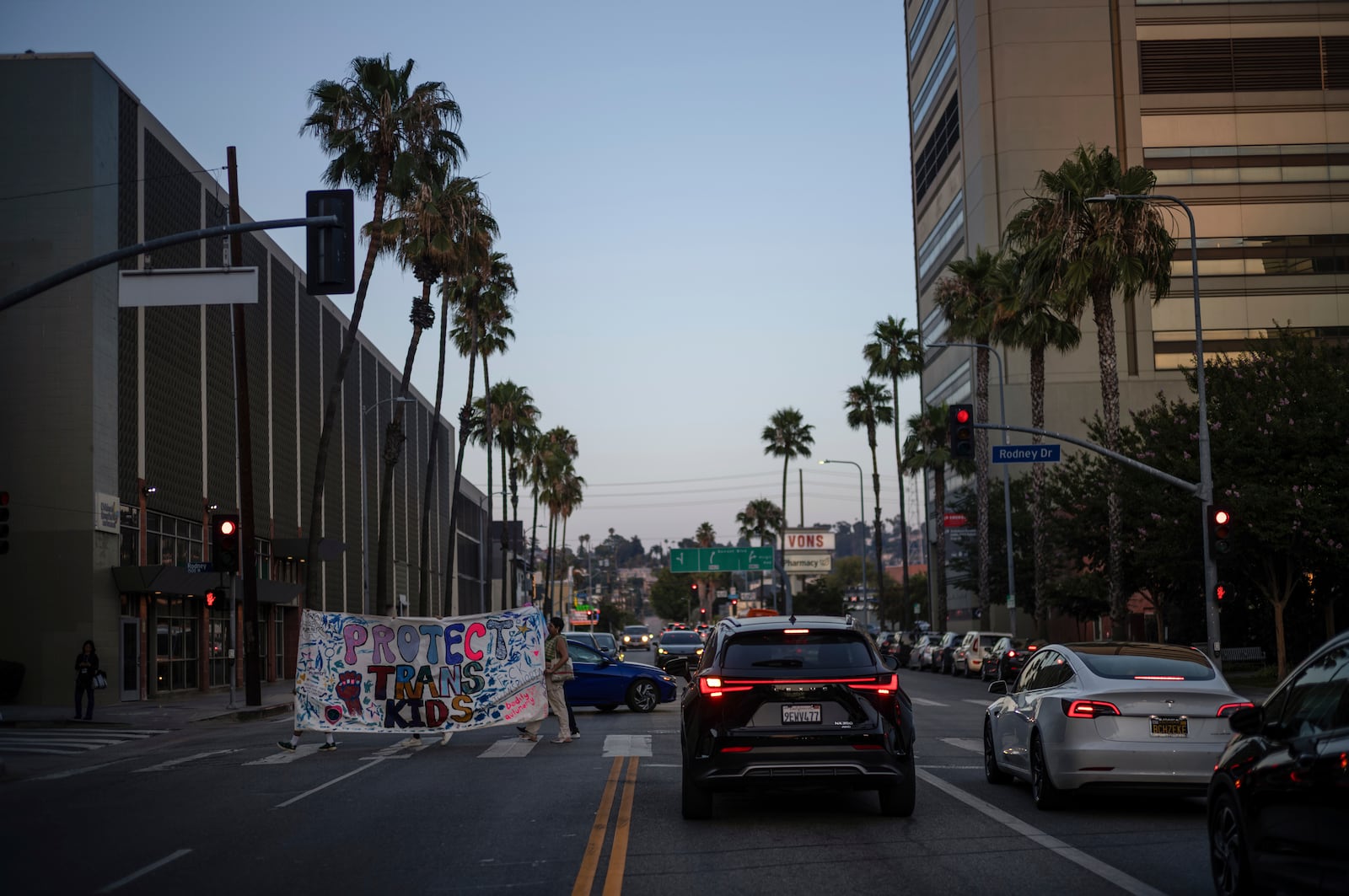 Protesters carry a large banner while demonstrating against the closure of the trans youth clinic at Children's Hospital Los Angeles, Thursday, July 3, 2025, in Los Angeles. (AP Photo/Jae C. Hong)