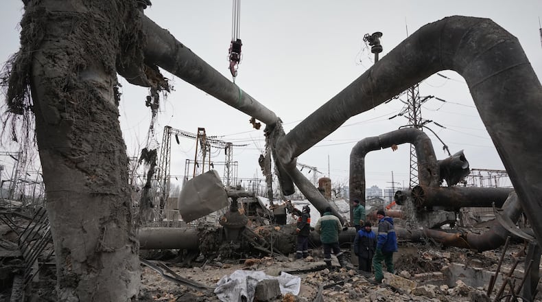 Workers clean up damage at Darnytsia Thermal Power Plant after a Russian attack in Kyiv, Ukraine, Wednesday, Feb. 4, 2026. (AP Photo/Sergei Grits)