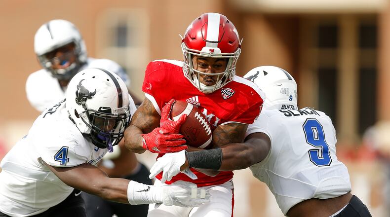 Kenny Young #3 of the Miami Ohio Redhawks is tackled by Khalil Hodge #4 and Tatum Slack #9 of the Buffalo Bulls during the first half at Yager Stadium on October 21, 2017 in Oxford, Ohio. (Photo by Michael Reaves/Getty Images)