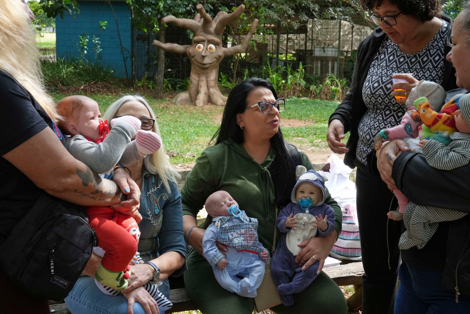 A group of women gather in a park to bond and show off their hyper-realistic reborn baby dolls, in Sao Paulo, Saturday, May 24, 2025. (AP Photo/Andre Penner)