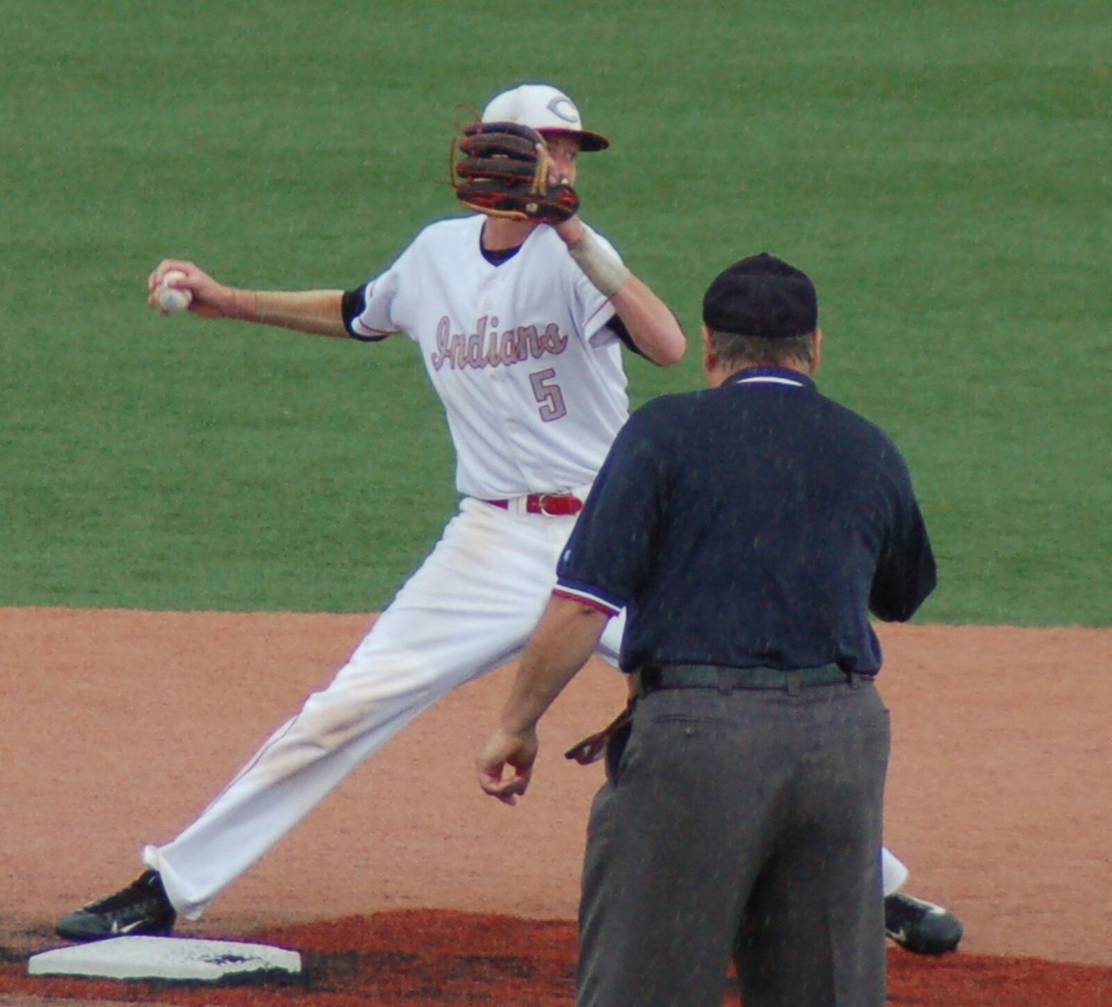 Carlisle second baseman Brandon Saylor is right in the middle of a 6-4-3 double play during Thursday’s Division III regional semifinal against Cincinnati Country Day at the Athletes in Action complex in Xenia. CONTRIBUTED PHOTO BY JOHN CUMMINGS