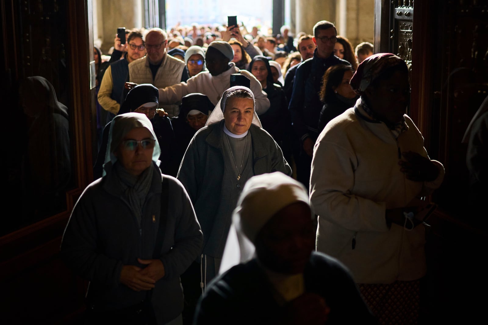 People line up as they enter St. Peter's Basilica to pay their respects to Pope Francis lying in state, at the Vatican, Thursday, April 24, 2025. (AP Photo/Emilio Morenatti)
