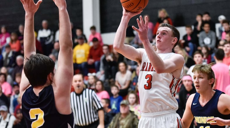Franklin’s Zack Minton puts up a shot over Monroe’s Nick Osterman during their game Jan. 26, 2018, at Franklin. The host Wildcats won 55-52. NICK GRAHAM/STAFF