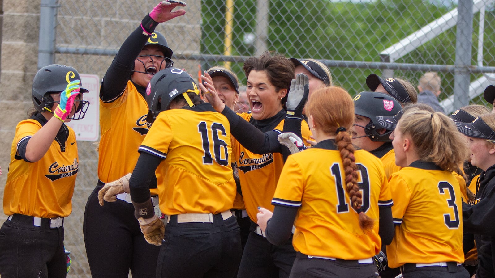 Natalie Carr (16) is mobbed at home plate after leading off the bottom of the first inning with a home run during the Elks' 8-1 victory over Lakota West in a Division I district final Thursday at Kings High School. Jeff Gilbert/CONTRIBUTED