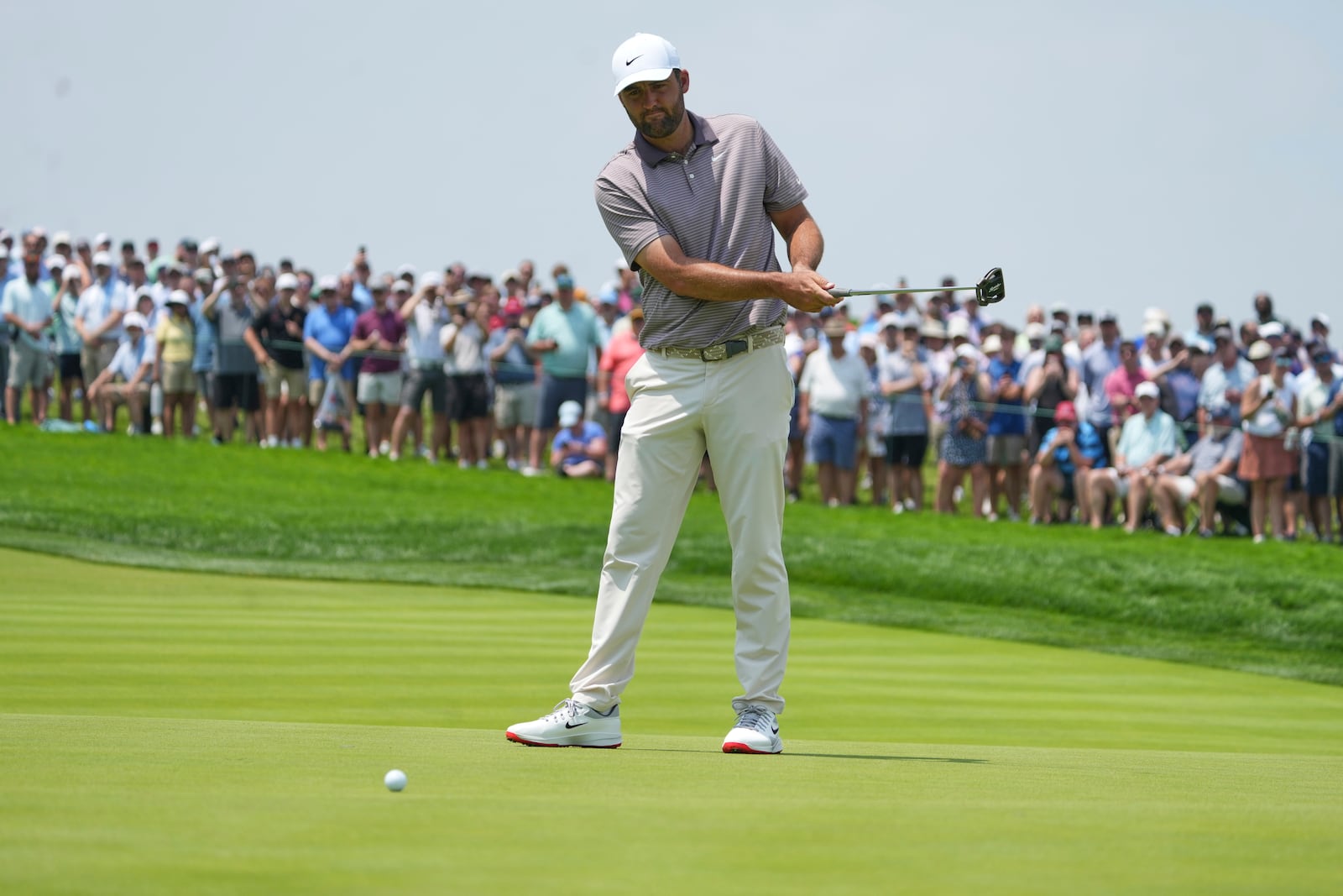 Scottie Scheffler reacts to his putt on the first hole during the first round of the U.S. Open golf tournament at Oakmont Country Club Thursday, June 12, 2025, in Oakmont, Pa. (AP Photo/Gene J. Puskar)