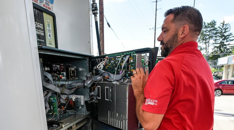 Tom Kamphaus of the Butler County Auditor’s Office checks for credit card skimmers Sept. 1 at the Marathon gas station at the corner of Cincinnati Dayton Road and Tylersville Road in West Chester Twp. NICK GRAHAM/STAFF