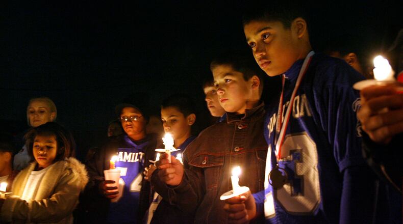 Members of Hamilton’s sixth-grade Little Blue football team gathered Monday Dec 12, 2007, outside the home of teammate DeMarcus Thomas, who was killed in a fire there earlier that morning. More than a 100 others were present to pay their respects. STAFF/NICK DAGGY