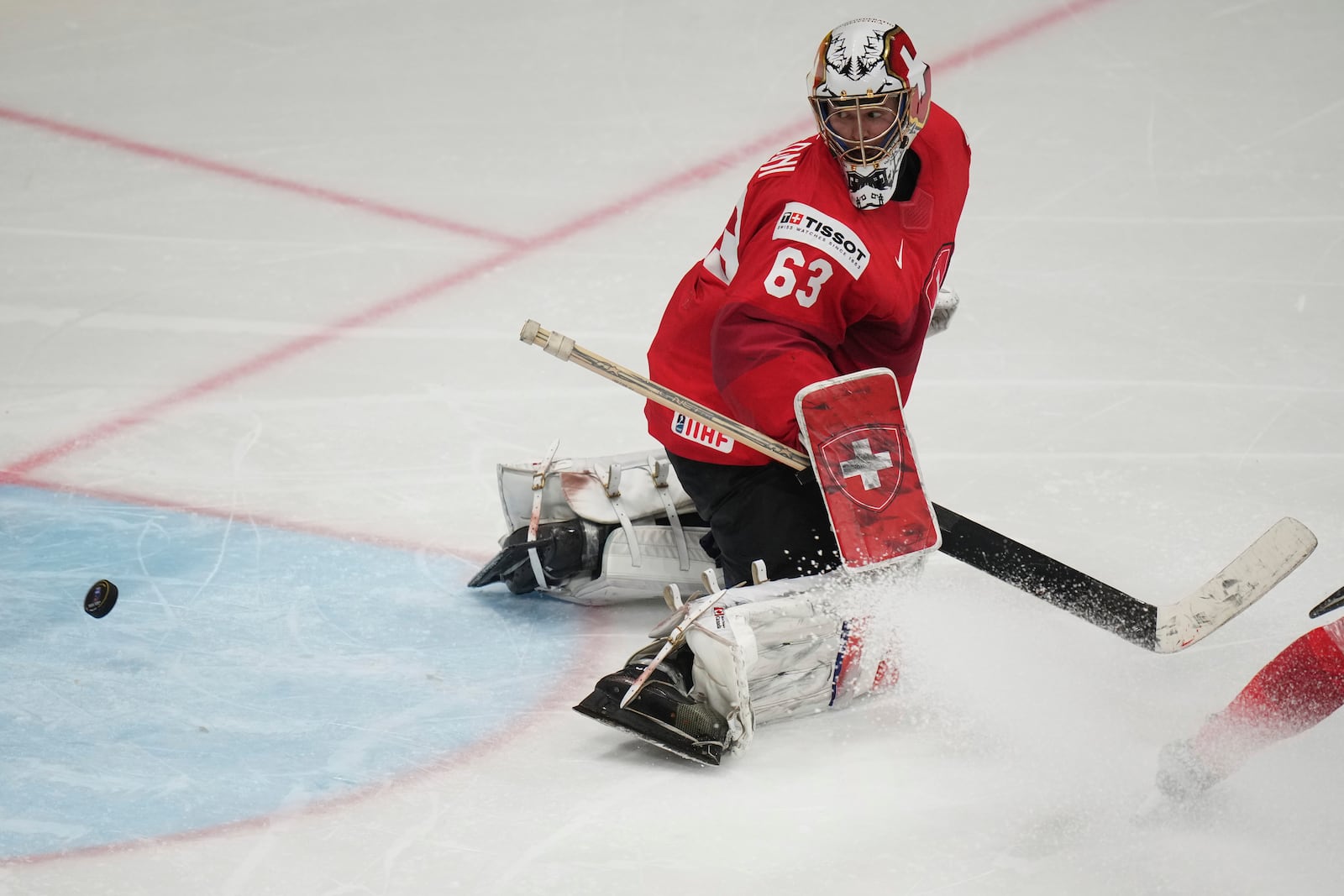 Switzerland's Leonardo Genoni watches the puck go into the net during sudden death overtime during the final match between United States and Switzerland at the ice hockey world championships in Stockholm, Sweden, Sunday, May 25, 2025. (AP Photo/Petr David Josek)