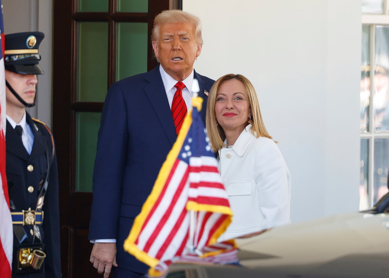 President Donald Trump, center, greets Italy's Prime Minister Giorgia Meloni, right, upon her arrival at the White House, Thursday, April 17, 2025, in Washington. (AP Photo/Tom Brenner)