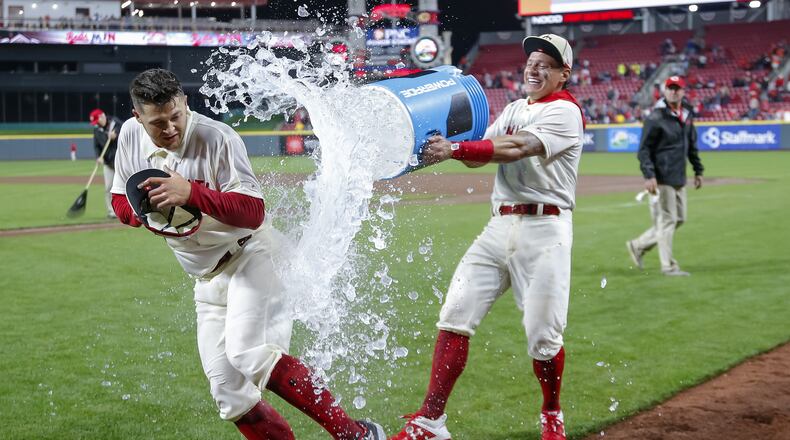 CINCINNATI, OH - MAY 04: Nick Senzel #15 of the Cincinnati Reds gets a celebratory soaking from Derek Dietrich #22 of the Cincinnati Reds following the game against the San Francisco Giants in which Senzel scored his first career home run at Great American Ball Park on May 4, 2019 in Cincinnati, Ohio. (Photo by Michael Hickey/Getty Images)