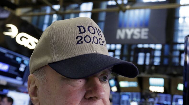 Arthur Cashin, director of floor operations for UBS Financial Services at the New York Stock Exchange, wears a Dow 20,000 hat, Wednesday, Jan. 25, 2017. The Dow Jones industrial average is trading over 20,000 points for the first time, the latest milestone in a record-setting drive for the stock market. The market has been marching steadily higher since bottoming out in March 2009 in the aftermath of the financial crisis. (AP Photo/Richard Drew)