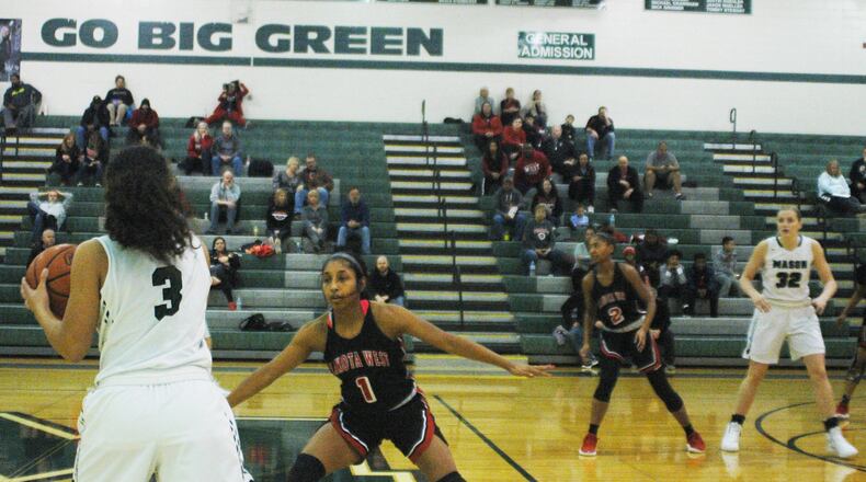 Lakota West’s Bryana Henderson (1) guards Mason’s Sade Tucker (3) during Saturday afternoon’s game at Mason. West won 81-41. RICK CASSANO/STAFF