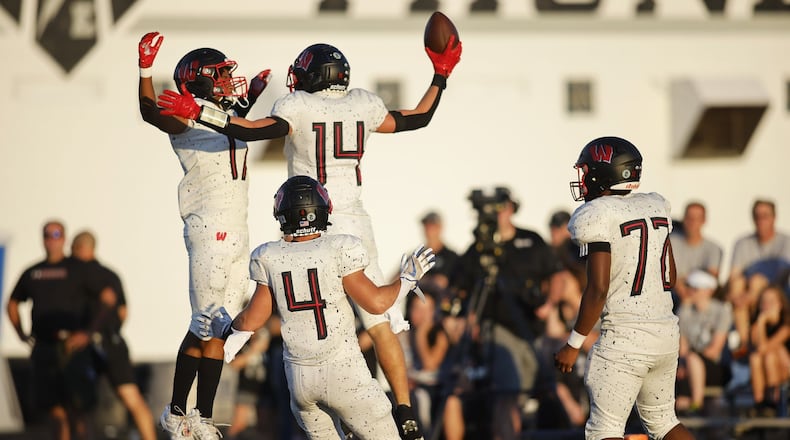 Lakota West players celebrate a touchdown Friday night's game at Lakota East. Nick Graham/STAFF