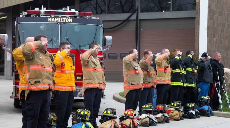 The funeral procession for Hamilton firefighter Patrick Wolterman passes by his fire station Thursday, Dec. 31. Wolterman died from injuries he sustained when he fell through the first floor of a home into the basement while battling a fire on Pater Avenue early Monday morning. GREG LYNCH/FILE