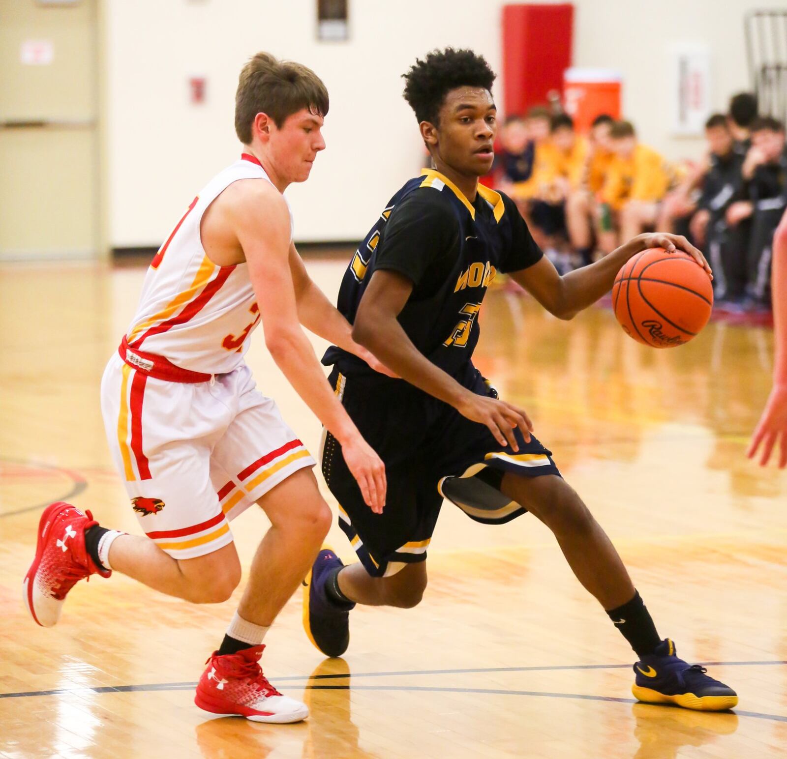 Monroe forward Tristan Backas (23) makes a move as Fenwick’s John Engelmeier (30) follows Tuesday night at Fenwick. GREG LYNCH/STAFF