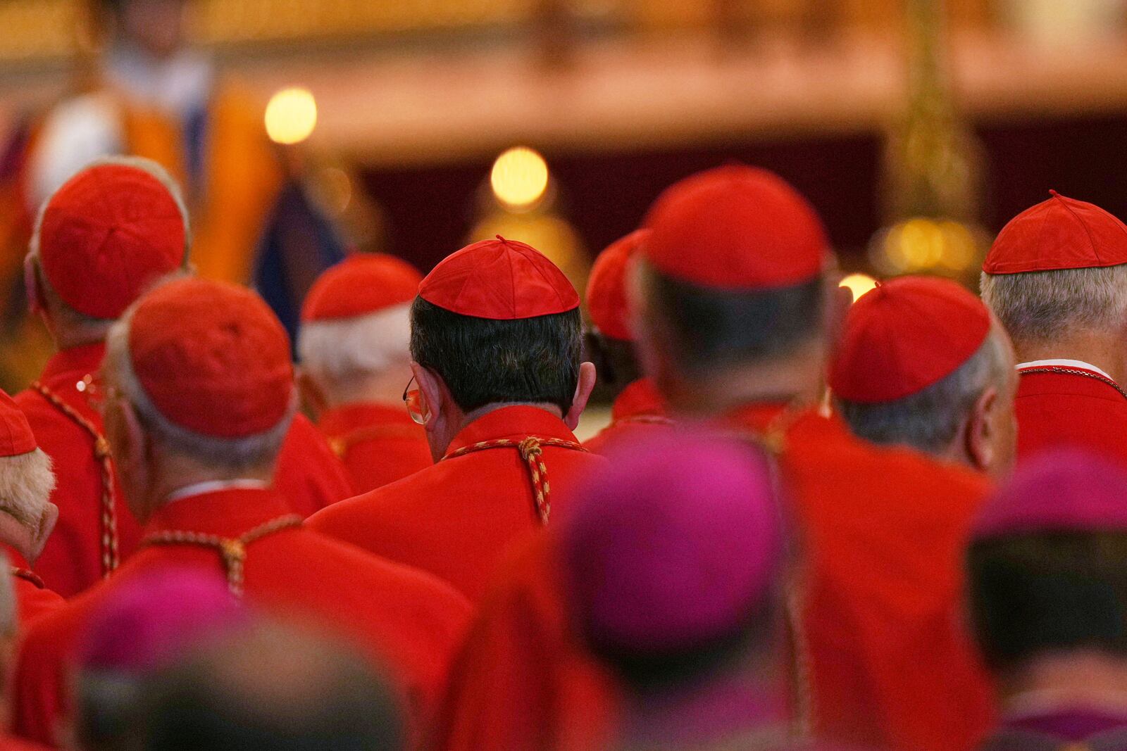 Cardinals stand by the body of Pope Francis, who will lie in state for three days, after it arrived in St. Peter's Basilica at the Vatican, Wednesday, April 23, 2025. (AP Photo/Francisco Seco)