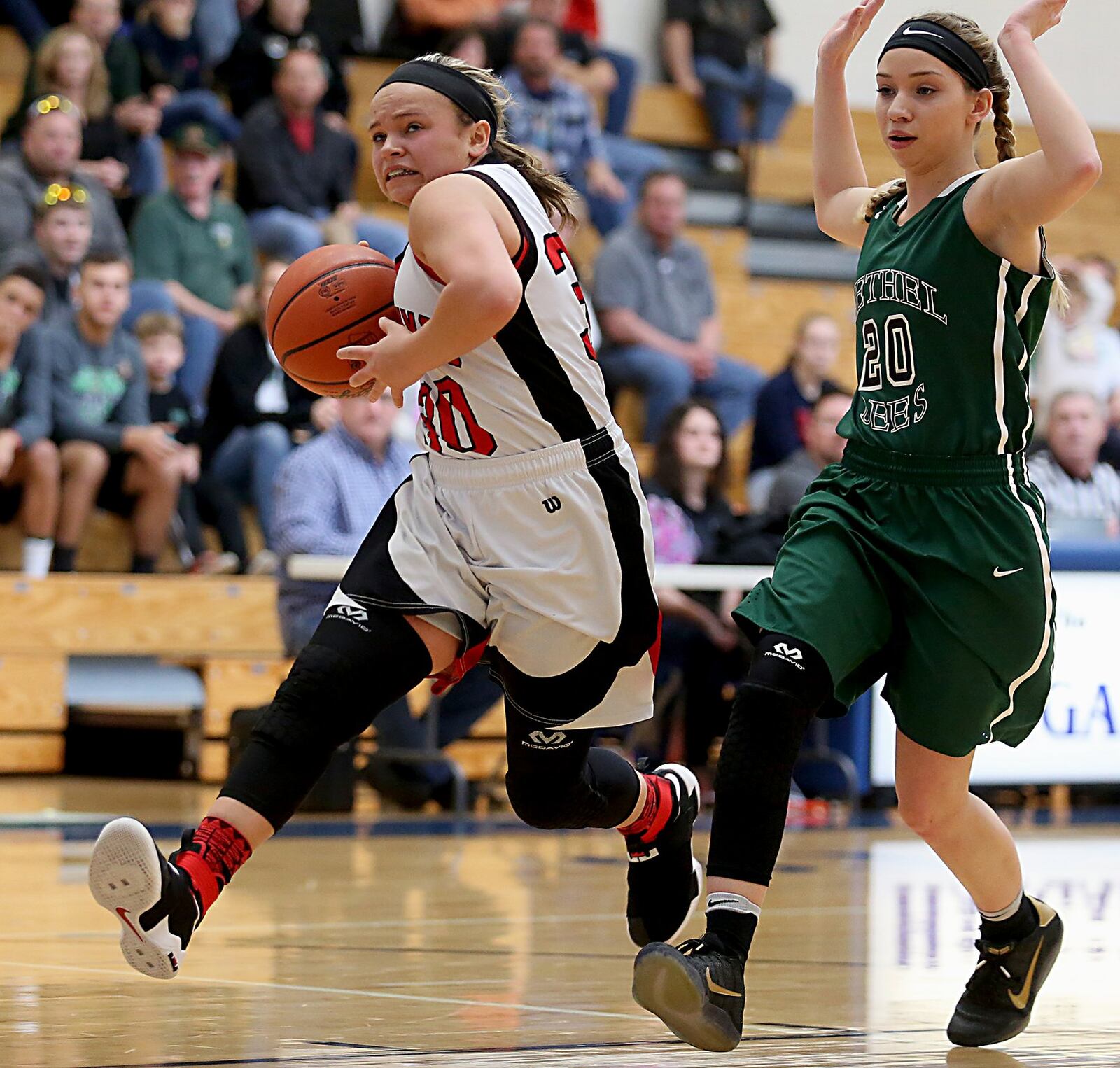 Madison guard Kenzi Saunders charges to the hoop with Tipp City Bethel guard Emily Crase in pursuit during their Division III sectional game at Franklin Monroe on Feb. 18. CONTRIBUTED PHOTO BY E.L. HUBBARD