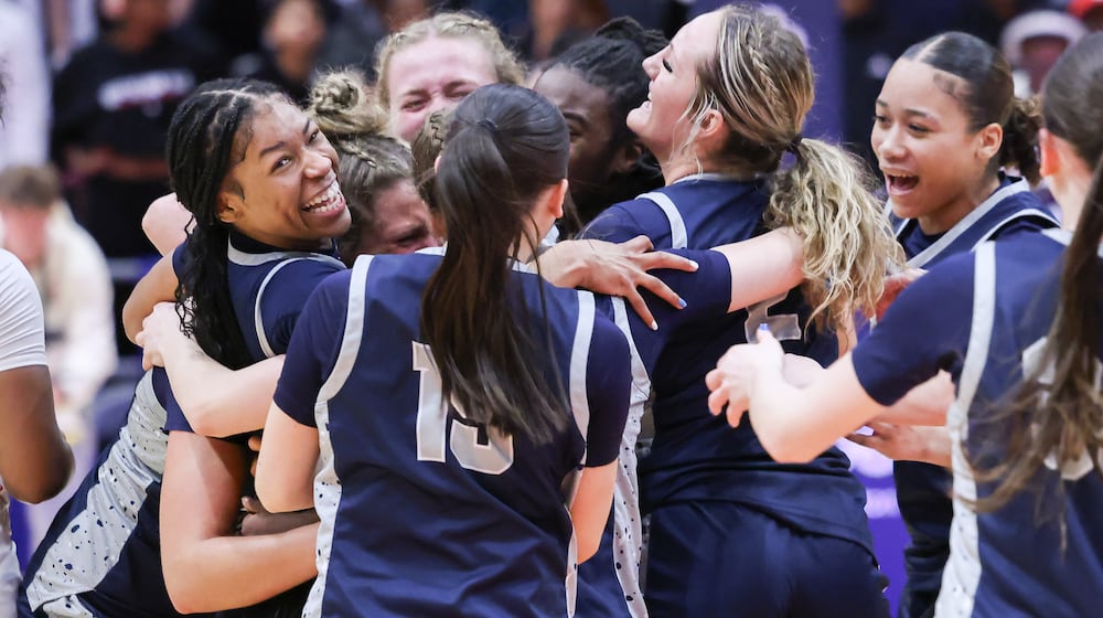 Fairmont senior guard Kaylah Thornton is mobbed by teammates during a celebration following the Firebirds' 61-55 victory over Princeton in the Division I state final on Saturday, March 14 at University of Dayton Arena. Thornton scored 19 points, including the game-tying 3 to send it to overtime. BRYANT BILLING / STAFF