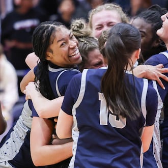 Fairmont senior guard Kaylah Thornton is mobbed by teammates during a celebration following the Firebirds' 61-55 victory over Princeton in the Division I state final on Saturday, March 14 at University of Dayton Arena. Thornton scored 19 points, including the game-tying 3 to send it to overtime. BRYANT BILLING / STAFF