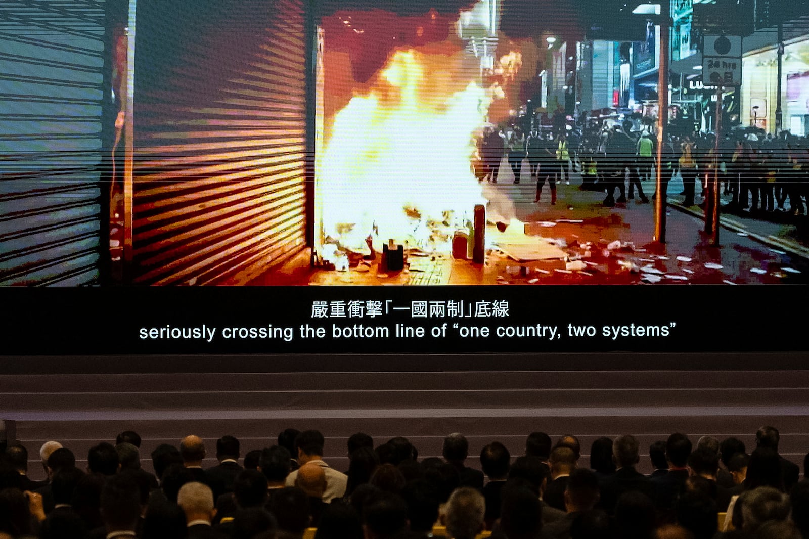 A video of the Anti-Extradition Bill movement in 2019 is displayed at the 5th anniversary of Hong Kong National Security Law Forum in Hong Kong, Saturday, June 21, 2025. (AP Photo/Chan Long Hei)