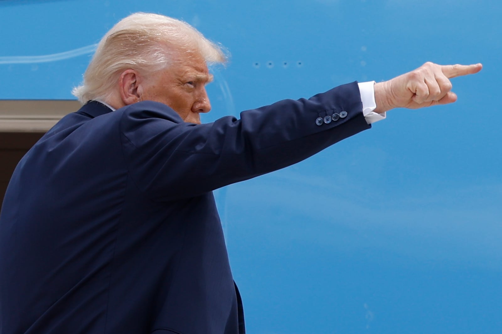 President Donald Trump gestures from the stairs of Air Force One as he boards upon his arrival at Joint Base Andrews, Md., Tuesday, July 15, 2025. (AP Photo/Luis M. Alvarez