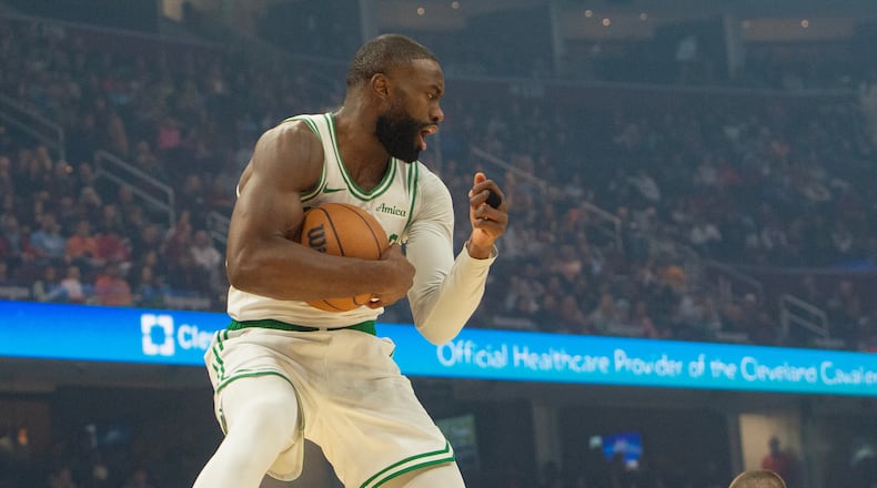 Boston Celtics' Jaylen Brown grabs a rebound against the Cleveland Cavaliers during the first half of an NBA basketball game in Cleveland, Sunday, Nov. 30, 2025. (AP Photo/Phil Long)