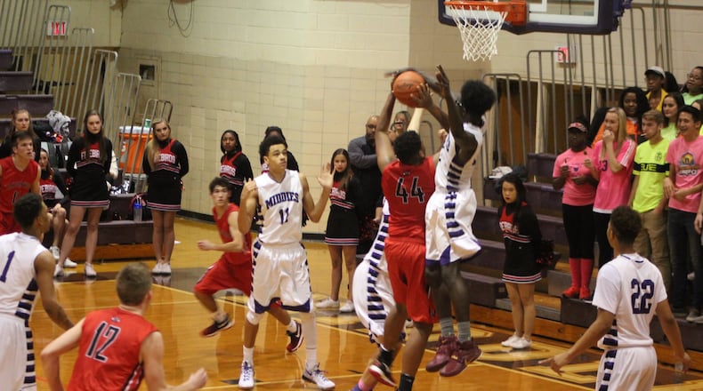 Middletown’s Jomar Bailey blocks the shot of Lakota West’s Malachi Hughes (44) on Jan. 10 at Wade E. Miller Gymnasium in Middletown. CONTRIBUTED PHOTO BY MARITZA MCKINNEY