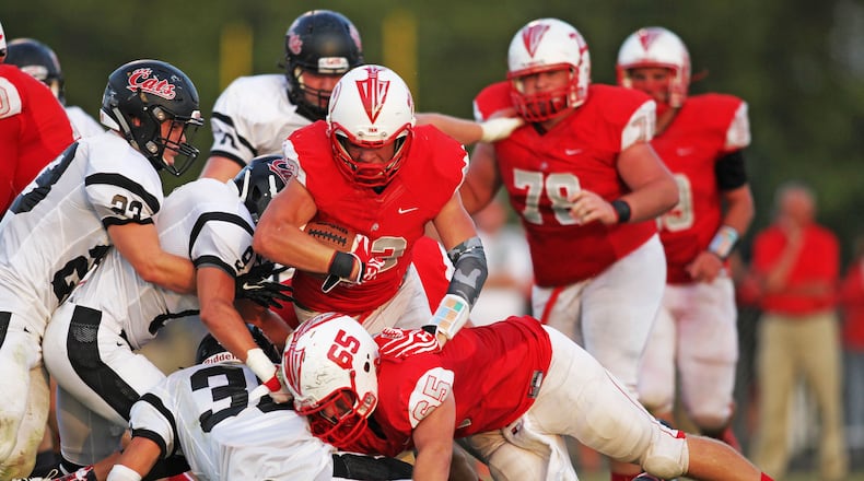 Carlisle’s Ridge Reed (22) gets a block by lineman Nick Moore (65) as he carries the ball during the first half of their game against Franklin on Aug. 28, 2015, at Carlisle’s Laughlin Field. The visiting Wildcats won 31-21. NICK GRAHAM/STAFF