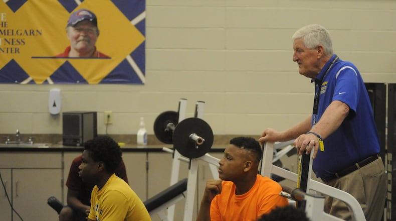 Ponitz head football coach Jim Place (right) and players. A generous donation by Ron Hemelgarn, a Chaminade grad, 1996 Indy 500 winner/owner and good friend of Ponitz head football coach Jim Place funded the Ron Hemelgarn Training Center at Ponitz last summer. MARC PENDLETON / STAFF