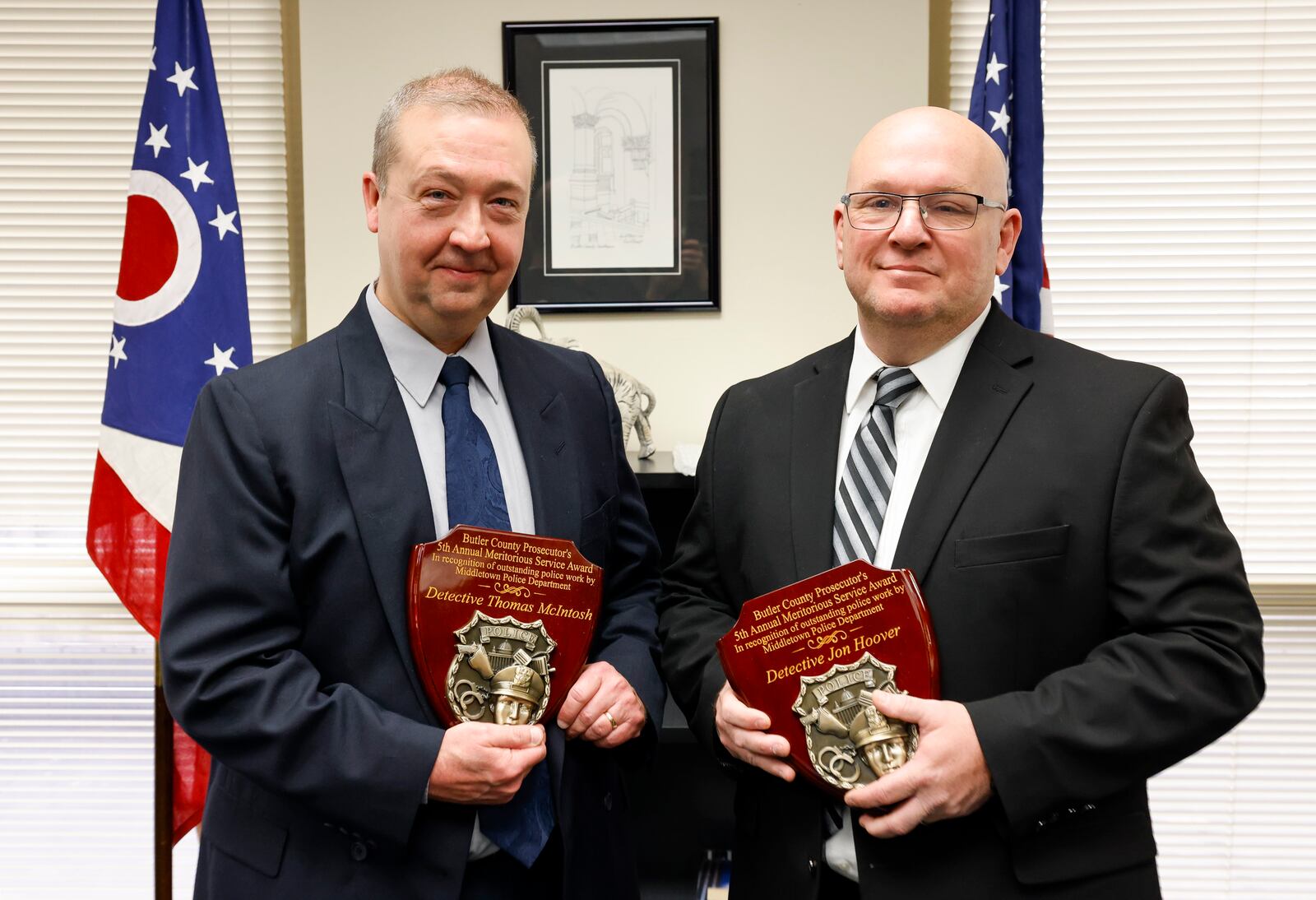 Middletown Division of Police detectives Tom McIntosh, left, and Jon Hoover were awarded the Butler County Prosecutor's 5th Annual Meritorious Service Award in recognition of their outstanding police work for the case involving the death of 6-year-old James Robert Hutchinson of Middletown. NICK GRAHAM / STAFF